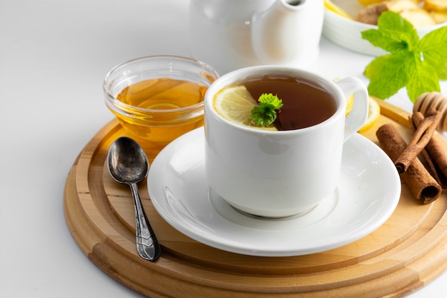 Cup tea with lemon and honey on a white . Hot tea cup isolated, top view. Autumn, fall or winter drink. copyspace.