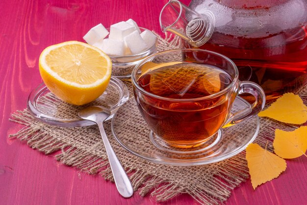 A cup of tea with lemon and sugar on a table