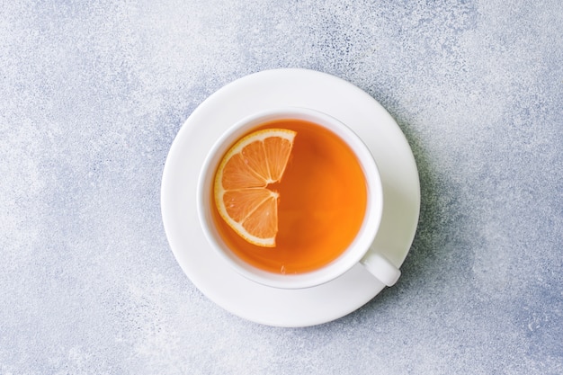 Cup of tea with lemon on the table. Top view.