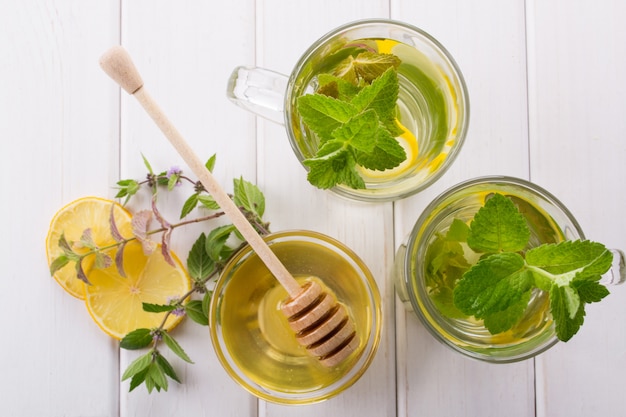 Cup of tea with mint, lemon and honey, cinnamon, anise. Top view