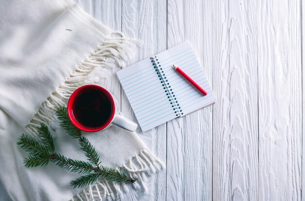 Cup of tea with scarf and notebook 