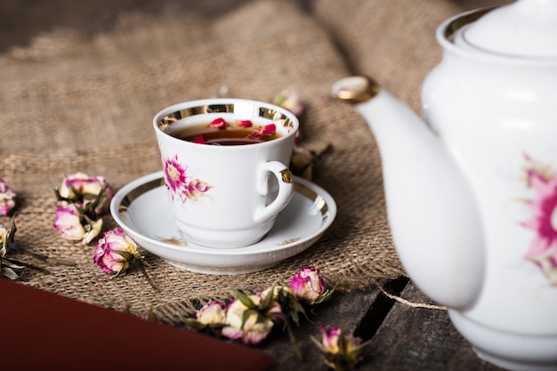 Cup of tea on wooden table with sackcloth