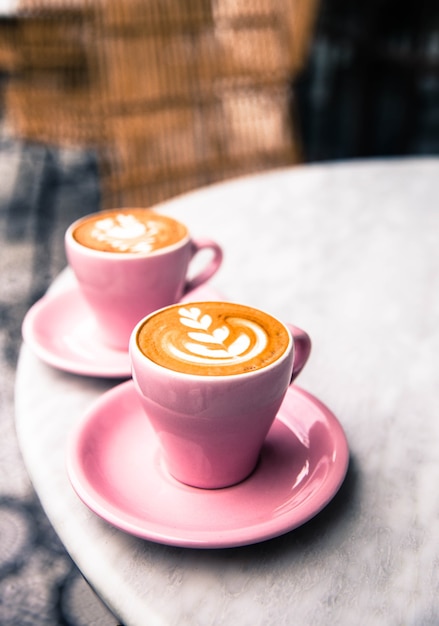 Cup of two hot cups of latte coffee on marble table background