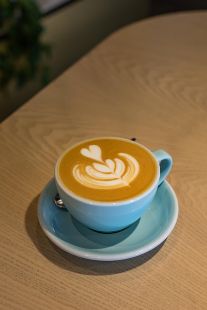 Cup with cappuccino or latte with milk foam in cafe or coffeehouse Simple workspace or coffee break