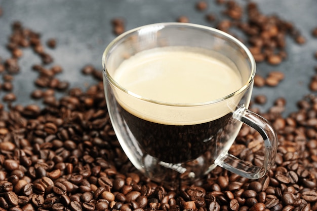 Cup with coffee and coffee beans