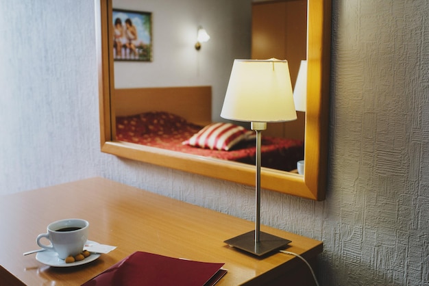 Cup with coffee on the table in the room