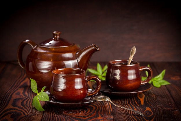 Cup with green tea on wood