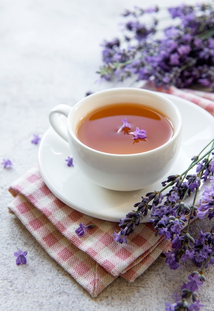 Cup with lavender tea and fresh lavender flowers