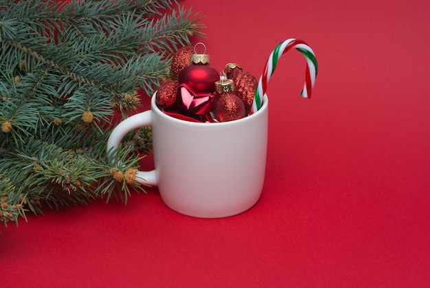 Cup with multicolored Christmas tree decorations