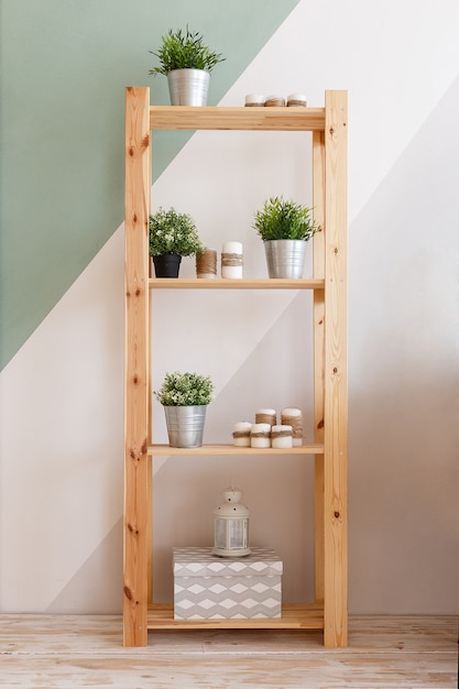 Cupboard decorated with candles, green plants