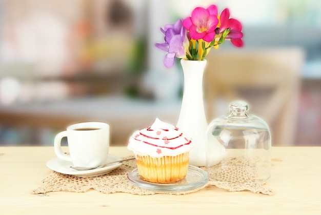 Cupcake on saucer with glass cover on bright background