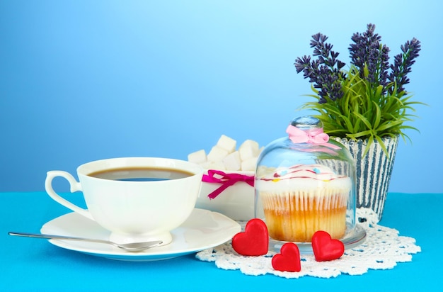 Cupcake on saucer with glass cover on color background