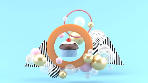 The cupcakes are in the center of the circle among the colorful balls on the blue space