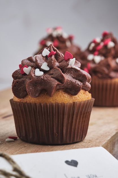 Cupcakes as a gift for loved ones. Orange cupcakes with chocolate cream.