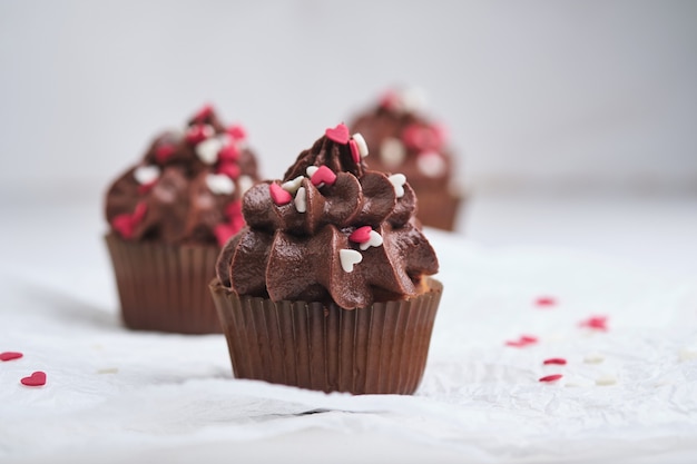 Cupcakes as a gift for loved ones. Orange cupcakes with chocolate cream.