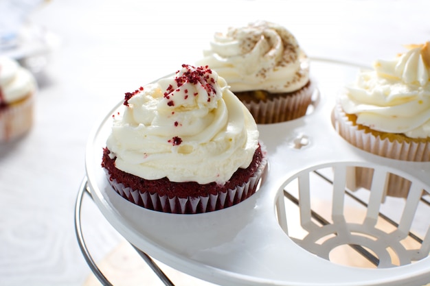 cupcakes of different flavors on a white wooden table