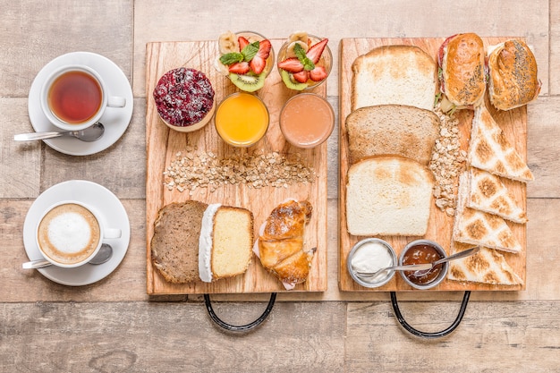 cups of coffee and tea and breakfast on wooden table