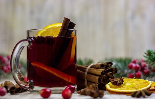 Cups with hot mulled wine on a wooden background. New year concept