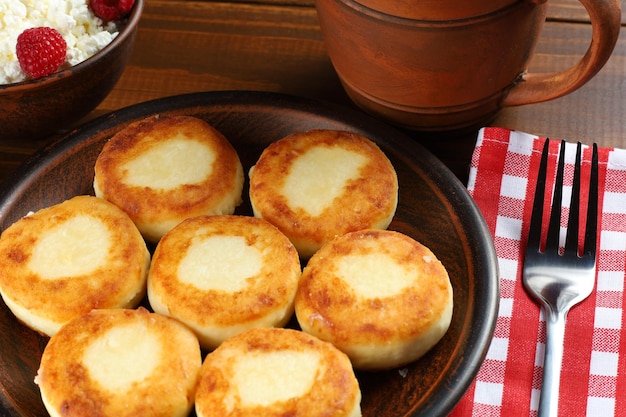 Curd fritters on a plate in the village Traditional delicious food Healthy and filling food Beautiful food photo