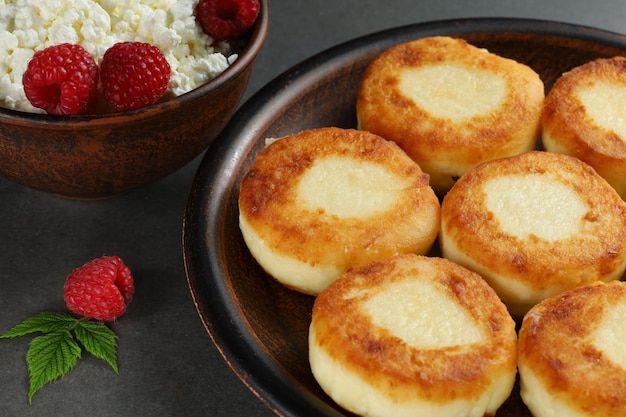 Curd fritters on a plate with raspberries Delicious homemade food