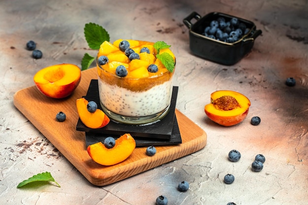 Curd or yogurt dessert with peaches blueberry chia Homemade dessert with fruits place for text top view