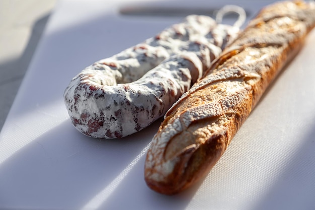 Cured sausage with white mold and french baguette