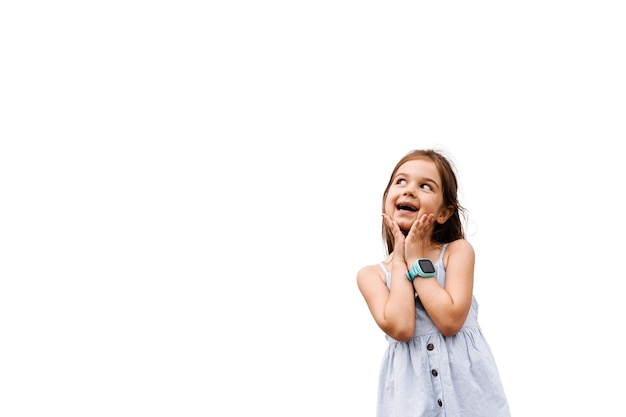 Curious adorable child girl on white background with empty place for advert Interested kid toddler posing in studio