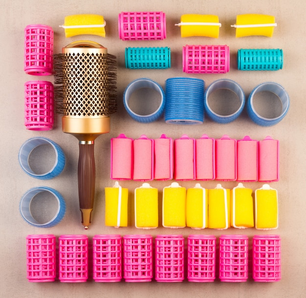 Curlers for hair of different colors and comb top view close-up