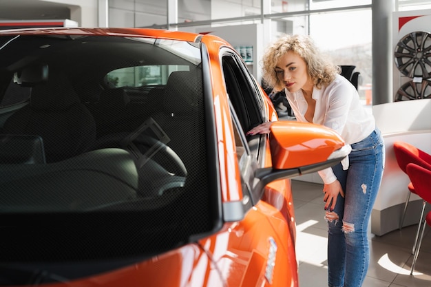 Curly blonde in a car dealership