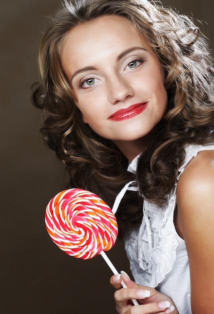 Curly  girl with a lollipop in her hand