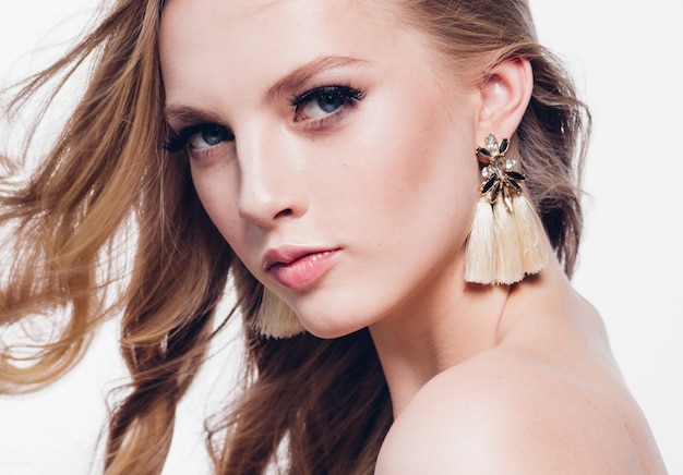 Curly hair blonde woman with long beautiful hairstyle and beauty lashes isolated on white. Studio shot.