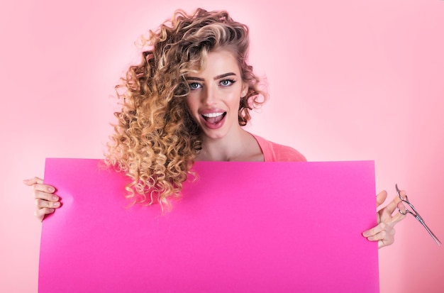 Curly hair girl with advertising board and scissors hairdresser beauty salon makeup and cosmetic