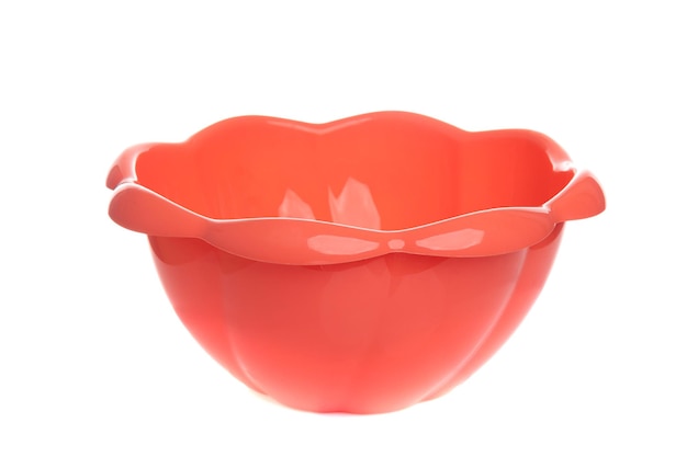 Curly plastic bowl empty peach color on isolated background