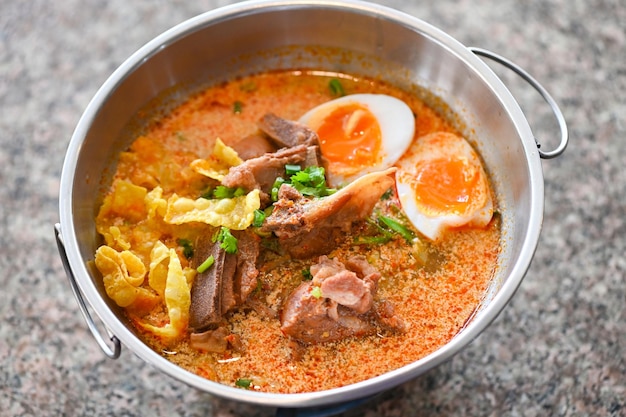 Curry bone soup pork bone soup with boiled eggs in hot pot Thai food tom yum hot and sour soup