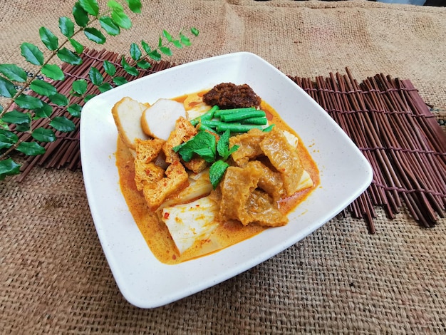 Curry Pig Skin Rice Noodle Roll served dish isolated on table top view of thai food