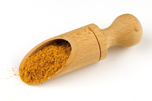 Curry powder seasoning in a scoop