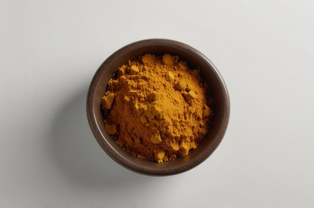 Photo curry powder spice from above bowl isolated on white