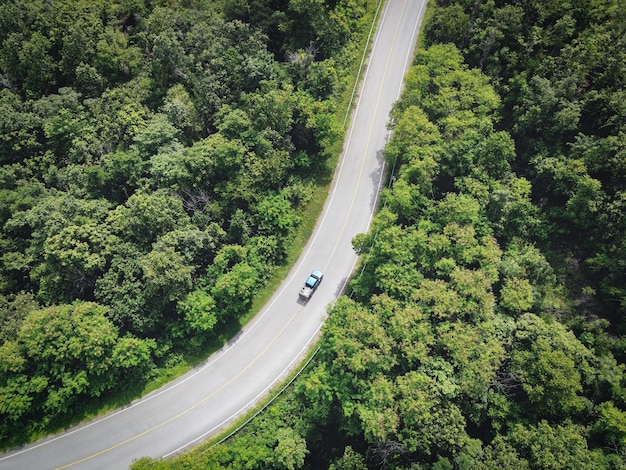 Curve road top Aerial top view rural road in the forest road and rain forest Aerial view road in nature Ecosystem and healthy environment