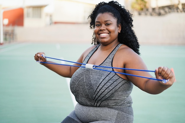 Curvy african woman doing workout session outdoor  Main focus on girl face