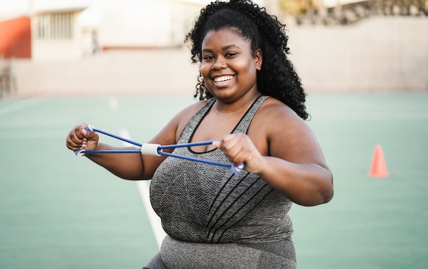 Curvy african woman doing workout session outdoor