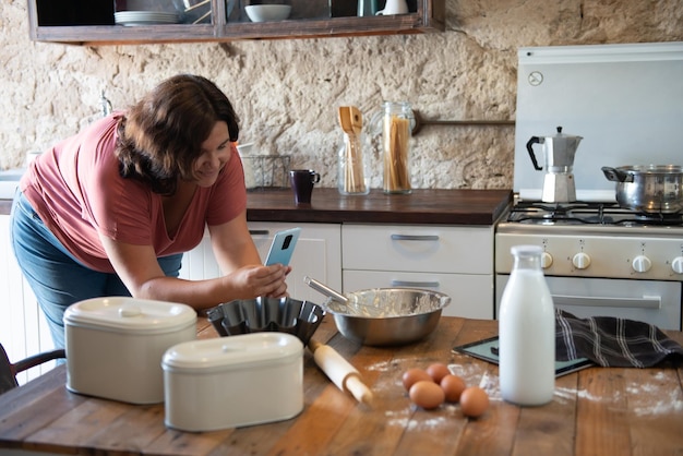 Curvy female foodie photographing what she has cooked to upload to social media