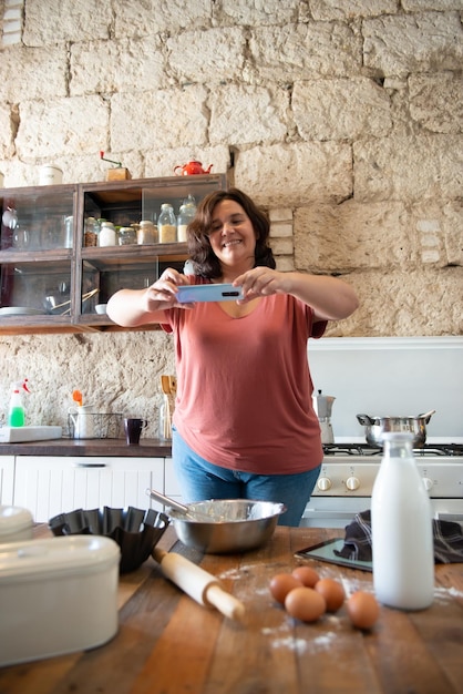 Curvy female foodie photographing what she has cooked to upload to social media