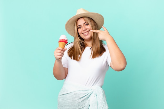 Curvy pretty blonde woman smiling confidently pointing to own broad smile