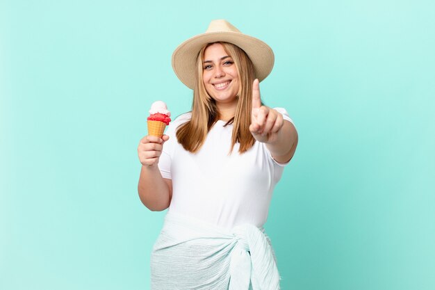 Curvy pretty blonde woman smiling proudly and confidently making number one