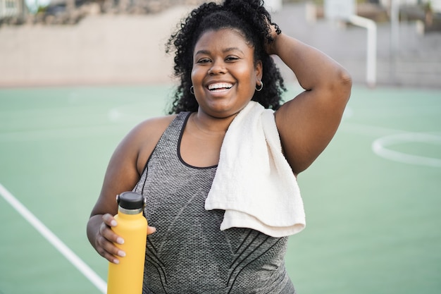 Curvy woman doing workout morning routine outdoor at city park