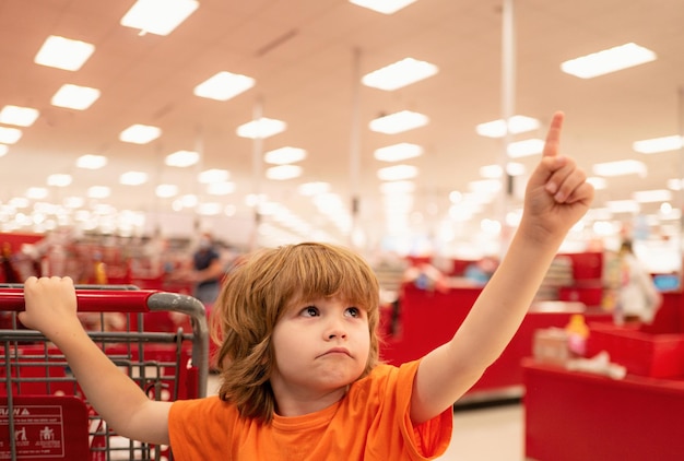 Customer child holdind trolley shopping at supermarket grocery store supermarket shopping with child