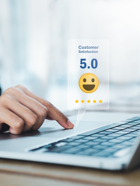 Customer review satisfaction feedback survey concepts The User give 5 stars rating with smile face icon to service experience business ranking on online application by laptop computer vertical