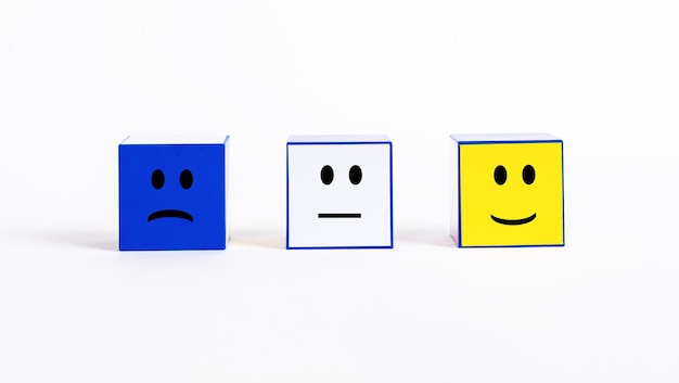 Customer satisfaction rating and feedback cubes with sad and smiley emotions negative neutral and po