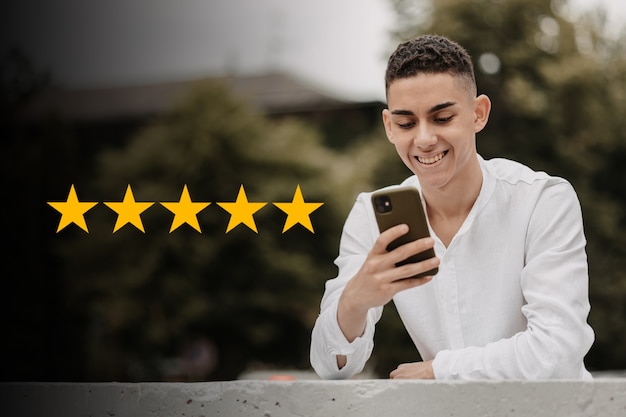 Customer service concept. Man with 5 stars score on his phone. Online ranking system.