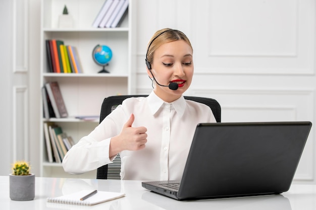 Customer service cute beautiful girl in white shirt with computer and headset showing ok gesture